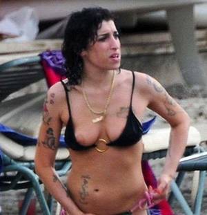 Amy Winehouse Porn - Topless Amy Winehouse showing her nice tits and multiple tattoos on the  beach