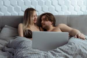 couple in bed - Premium Photo | Couple watching porn movie over laptop in bedroom