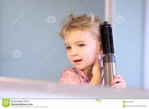 Blonde Toddler Girls Porn - Little girl brushing her hair. Hands, female.
