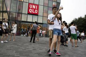 china couple sex homemade - A Chinese couple take a selfie outside the Uniqlo flagship store where a  steamy video purportedly taken inside one of its fitting room showing a  couple ...