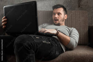 couch masturbation - A man watches an adult video on a laptop while sitting on the couch. The  concept of porn, masturbation, male needs, pervert, lust, desire,  loneliness. Stock Photo | Adobe Stock