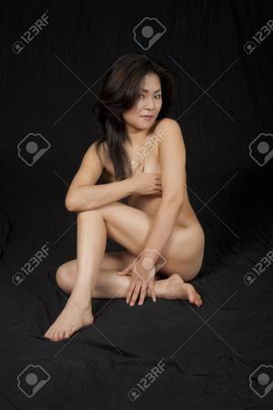 naked asian photography - Beautiful and sexy Asian woman posing for a nude figure study on a black  background Stock