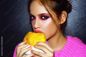 Burger Girl Porn - Woman eats a burger, food. Food porn. Teen girls enjoying delicious burgers  in cafe. Beautiful young girl in studio on gray background and perfect  makeup. foto de Stock | Adobe Stock