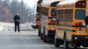 Middle School Bus Porn - A police officer blocks the entrance to the school on April 9.