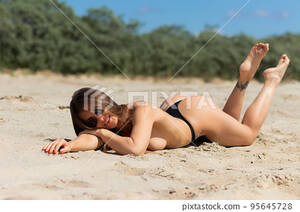 beach girls naked webcam - Topless woman lying on beach - Stock Photo [95645728] - PIXTA