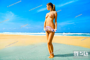girl on nude beach sex - Nude girl at the beach holding a fish, Stock Photo, Picture And Rights  Managed Image. Pic. EXA-A50818 | agefotostock