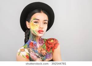 latina nude body paint - Gorgeous girl with dark long hair wearing black hat, body art paintings on  neck,