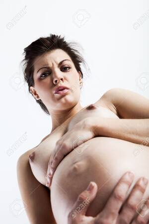 Attractive Pregnant Belly Porn - Pregnant young woman holding her nude belly in pain Stock Photo - 6102097