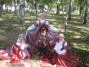 Elizabethan Costume Porn - Three Cossack girls in traditional costumes and a little boy in his Cossack  uniform. #
