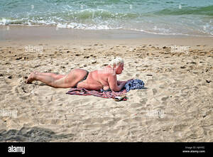 fat tan girls naked - Fat women sunbathing beach hi-res stock photography and images - Alamy