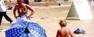 hot nude beach sunbathing - Foreign Woman Caught Sunbathing Topless in Qingdao