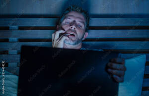 cyber sex movie - man alone in bed playing cybersex using laptop computer watching porn sex  movie late at night with lascivious pervert face expression in internet  pornographic sexual content Stock Photo | Adobe Stock