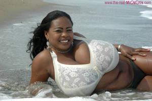 black bbw boobs in bra - Black cutie teasing on the beach anf taking off her bra just to expose her  heavy breasts.