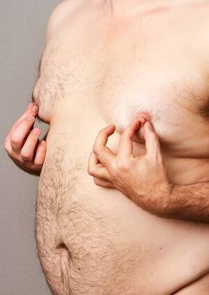 Fat Chub Squeezes Boobs Porn - Fat man at his nipples Stock Photo by Â©txking 12122857