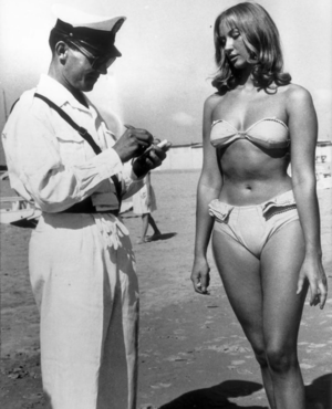 50s nude beach - A police officer issuing a woman a ticket for wearing a bikini on an  Italian beach, 1957. : r/pics