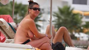 milfs topless at the beach - Cute milfs tanning topless on a beach vacation