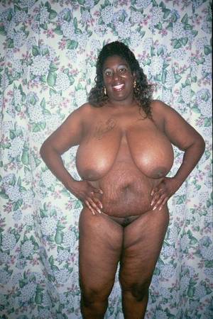 black mama fat - Fat mom with huge heavy melons strips nude and poses with smile on her face