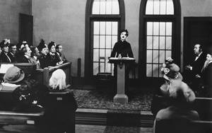 Future Black 80s Porn - A black-and-white photo of Charlie Chaplin at a podium, surrounded by