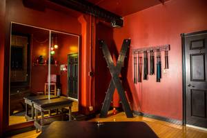 adult tied spanking bench - The Red Room - One of the beautiful play rooms featuring a bondage table,  spanking