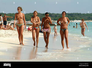 native nudism gallery - four young semi-nude women walking along the beach, Spain, Balearen Stock  Photo - Alamy