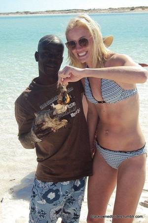 interracial ritual - White women with black men flirting, swimming and relaxing-- all part of the