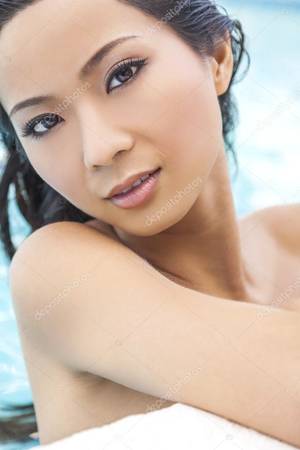 asian nude swimming - A beautiful sexy nude naked young Chinese Asian woman leaning on side of  turquoise blue spa swimming pool. Spa, healthy living and health club  concept.