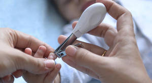 British Schoolgirl Finger Porn - Hands cutting a baby's nails