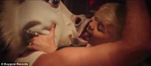 Miley Cyrus Kissing Porn - Miley Cyrus tongue kisses fiancÃ© Liam Hemsworth, who's dressed in a unicorn  mask in new edgy music video | Daily Mail Online