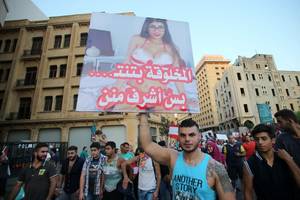 Beirut Porn - A Lebanese protester raises a poster bearing an image of Lebanese-American  porn star Mia