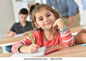 cutie schoolgirl - Cute schoolgirl in class writing on notebook