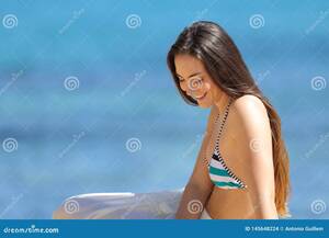 exotic beach babes voyeur - Candid Woman in Bikini Sitting on the Beach Stock Photo - Image of adult,  meditating: 145648224