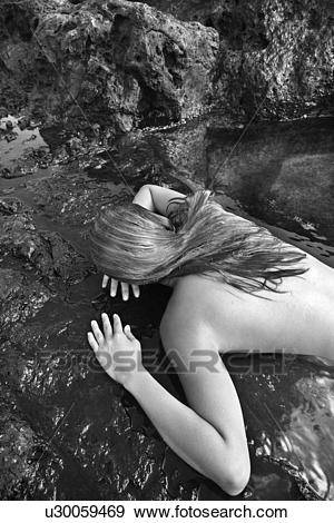beautiful asian face down nudes - Stock Photograph - Young nude Asian woman lying face down on rocks..  Fotosearch -