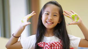 Hd Tiny Teen - little asian girl with painted palms - HD stock video clip