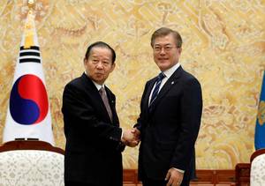 Korean Elementary School Sex - South Korean President Moon Jae-in (right) shakes hands with Toshihiro  Nikai,