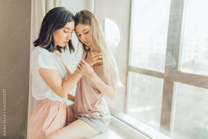 Forced Into Lesbian Sex - two lesbians making love indoors. close up photo. copy space. sexual  behavior concept. females going to have sex. woman holding a shoulder of  other one Stock Photo | Adobe Stock