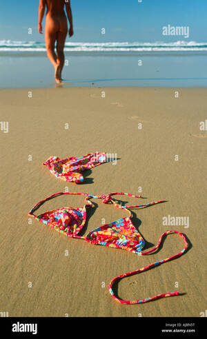 model walking on beach naked - Woman Walking Along Beachfront in the Nude Stock Photo - Alamy