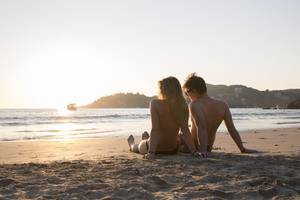 mexico hidden beach sex - Young couple relax on beach, listen to music