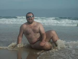 fat hairy nude beach - Fat hairy chested bear in shades poses nude in wet sand on the wild beach