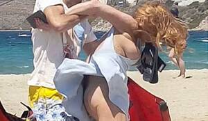 lindsay lohan topless beach boobs - Lindsay Lohan Sideboob Fight at the Beach! - The Nip Slip