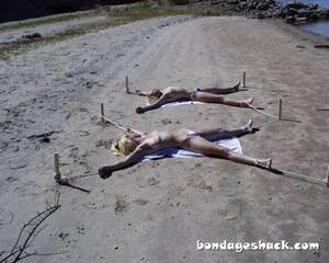 beach girl naked bondage - sirrendre: two young women staked out topless on the beach Bondage by the  beach! Tumblr Porn