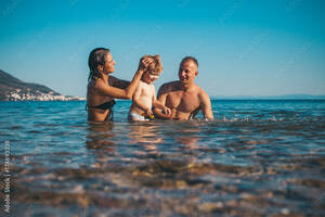 any nudism gallery - Family. Dream. Mother and father. Happy day. Childhood. Nude photo.  Lifestyle. Sea background. Stock Photo | Adobe Stock