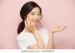 Korean Elementary School Sex - Smiling Korean girl applying moisturizer on her face