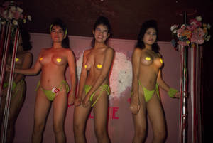 bar 3 nudist girls - Semi-nude bar girls on stage in a bar in the Patpong District.