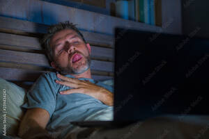Facial Sleeping - man alone in bed playing cybersex using laptop computer watching porn sex  movie late at night with lascivious pervert face expression in internet  pornographic sexual content Stock Photo | Adobe Stock