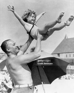 nude beach freedom - Shirley Temple, screen sensation, is shown being tossed in the air by...  News Photo - Getty Images