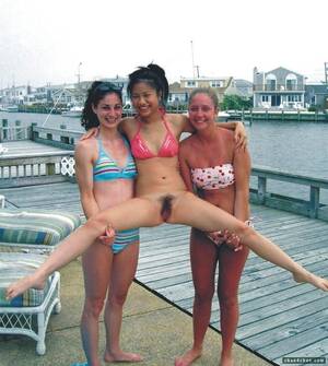 asian nudist friends - Two friends holding up a naked one. Porn Pic - EPORNER