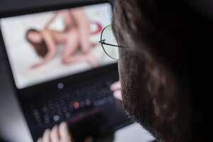 Men Watching Porn - Man watching pornography on laptop at home stock photo