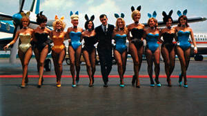 1960s Playboy Porn - Hugh Hefner flanked by Playboy bunnies in the 1960s