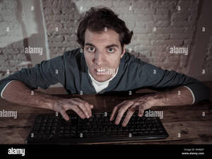 Internet Home Porn - Addict young man alone at night on computer laptop working, online  gambling, watching porn or playing games late at home or using the internet  chat so Stock Photo - Alamy