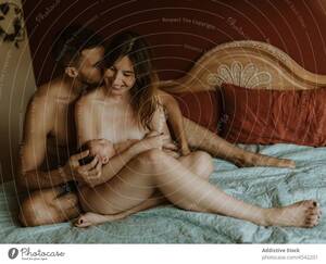 married nudist couples nude photo - Happy naked couple with baby cuddling on bed - a Royalty Free Stock Photo  from Photocase